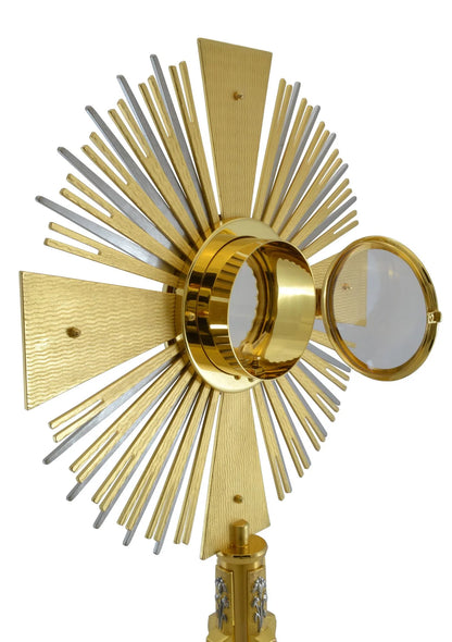 Monstrance in brass with red stones